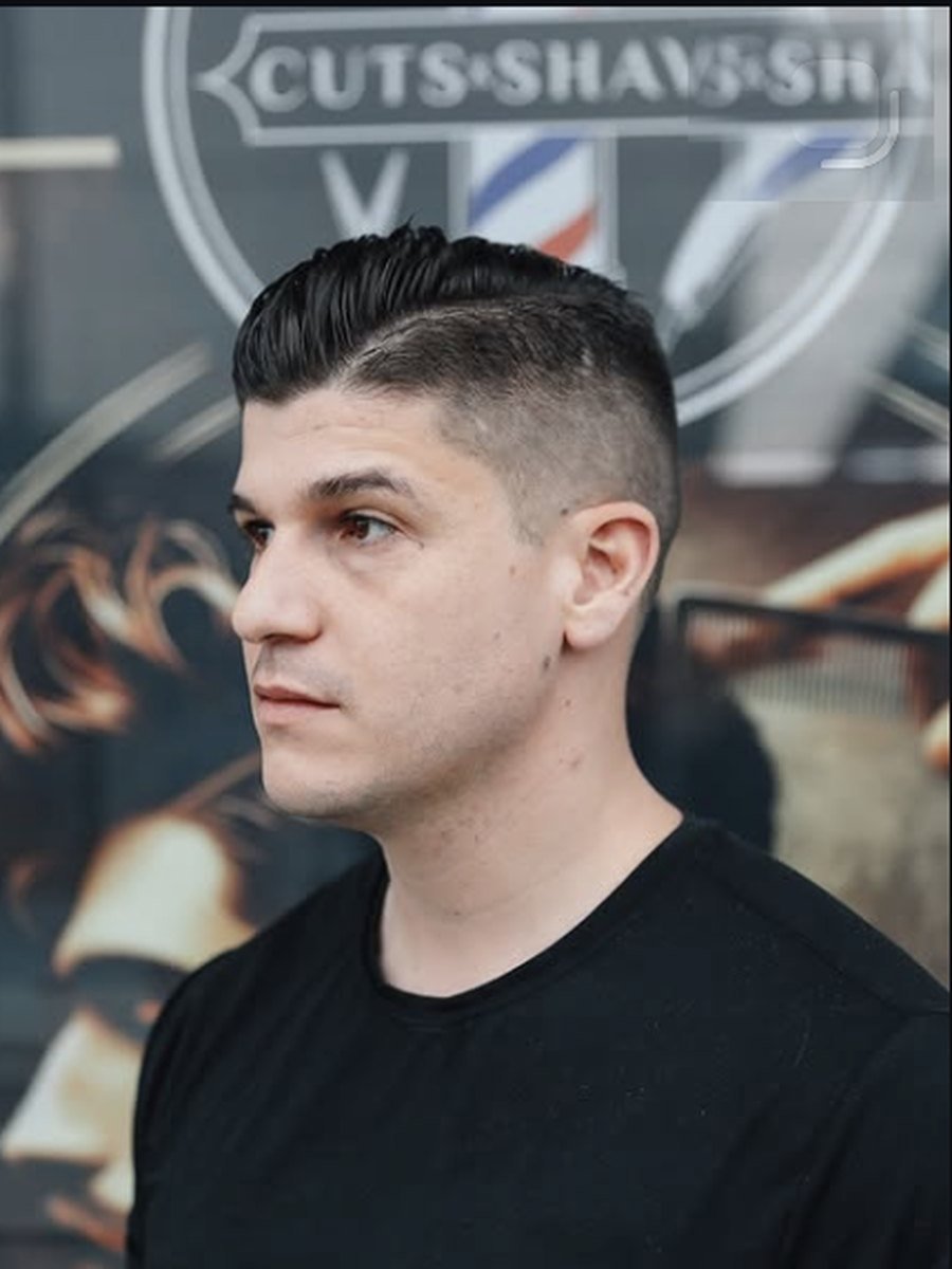 Sharp skin fade with a styled top, cut at Plaza Barber Shop at Plaza Barber Shop West Hempstead