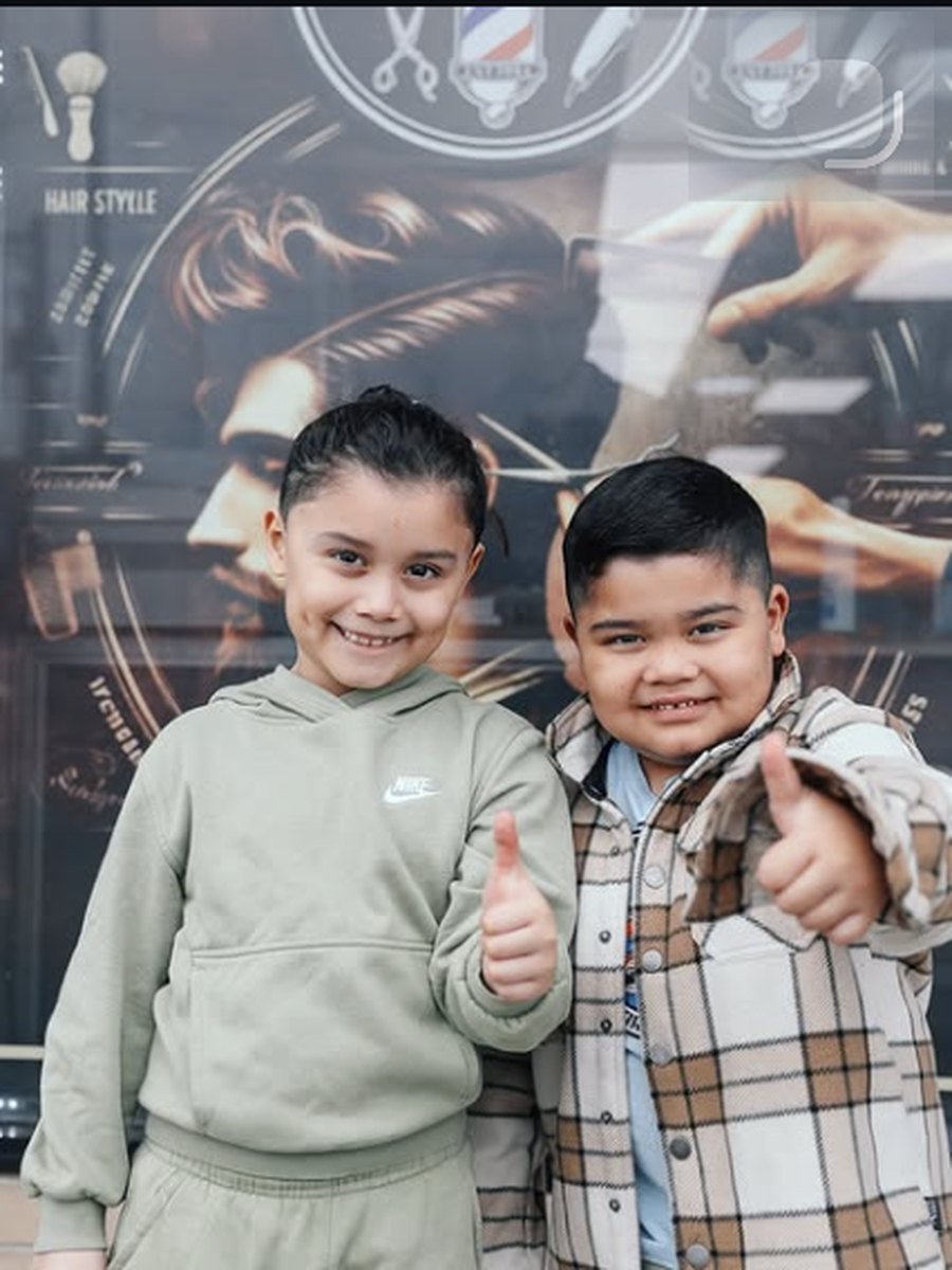 Two young clients after their haircuts at the child friendly barber shop at Plaza Barber Shop West Hempstead