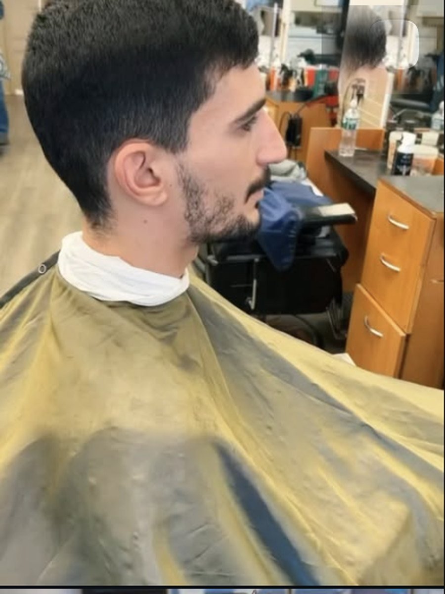 Client with a tapered fade and beard line-up at Plaza Barber Shop West Hempstead